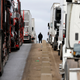 A man stands between California-bound trucks at a standstill.